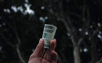 person holding U.S. dollar banknote